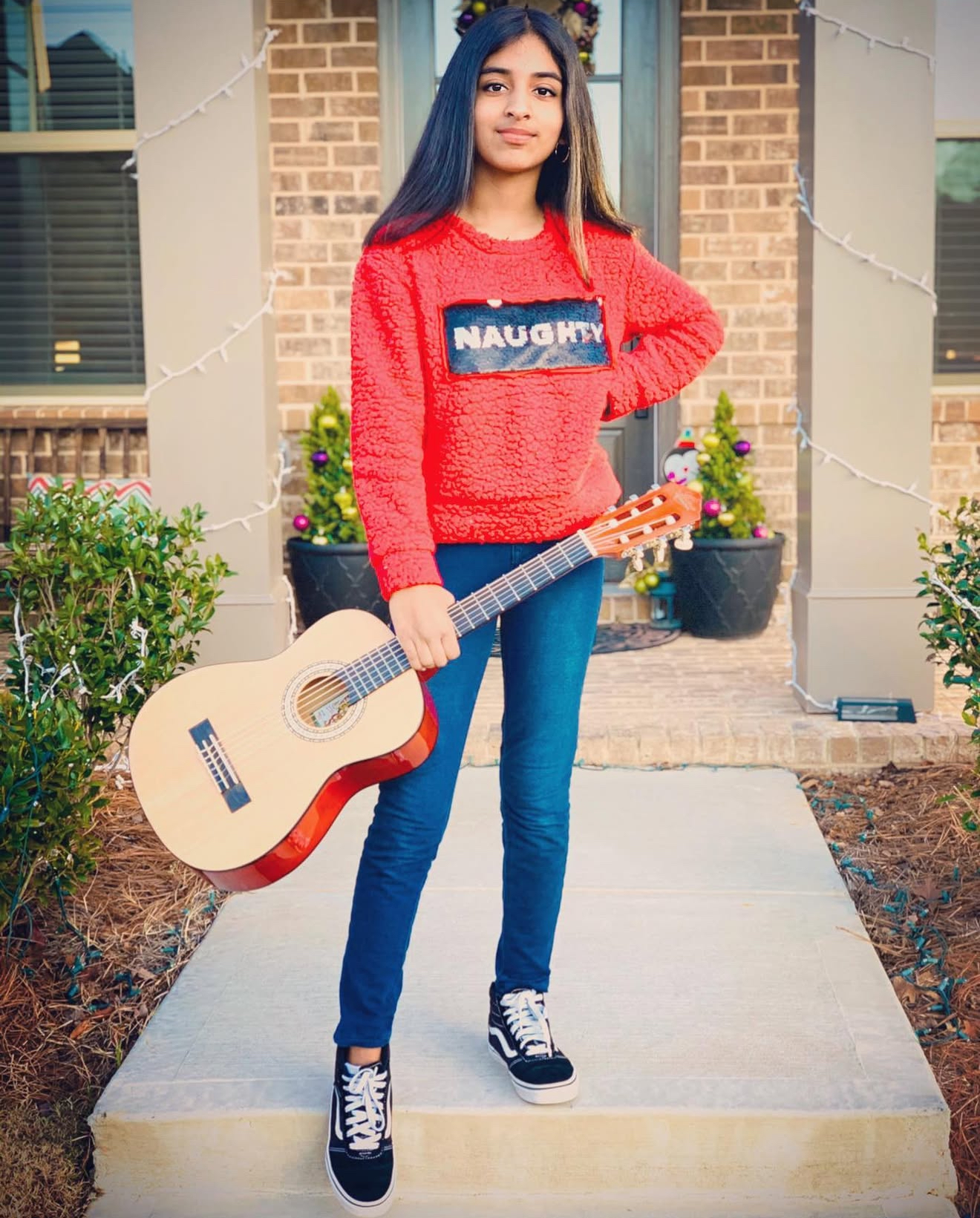 Kate with guitar in festive attire